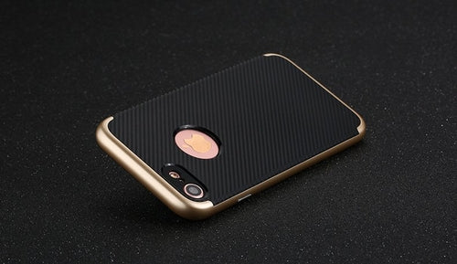 Phone case with black and gold design on a dark background
