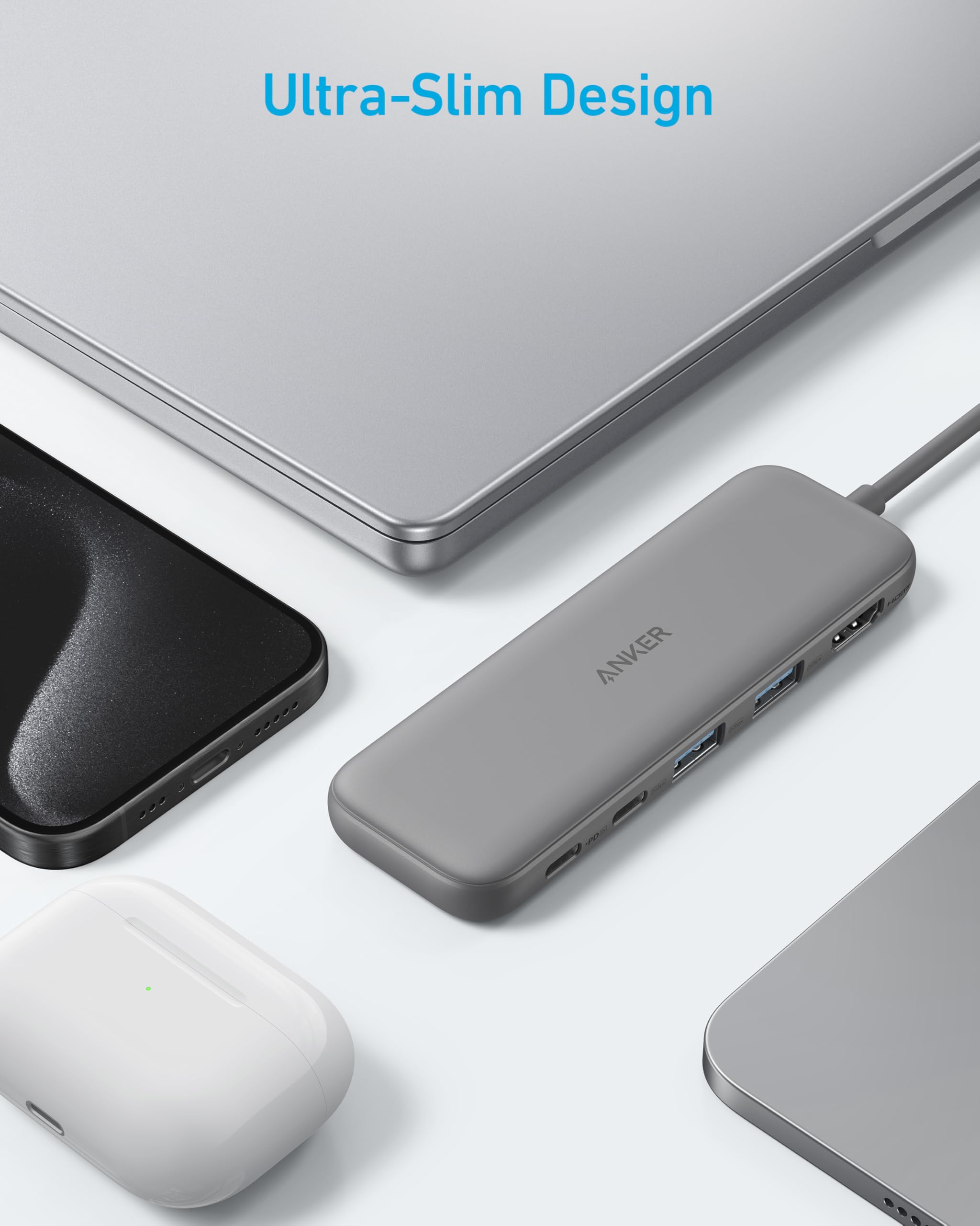 Gray USB hub with multiple ports on a white surface, featuring the brand 'Anker'.