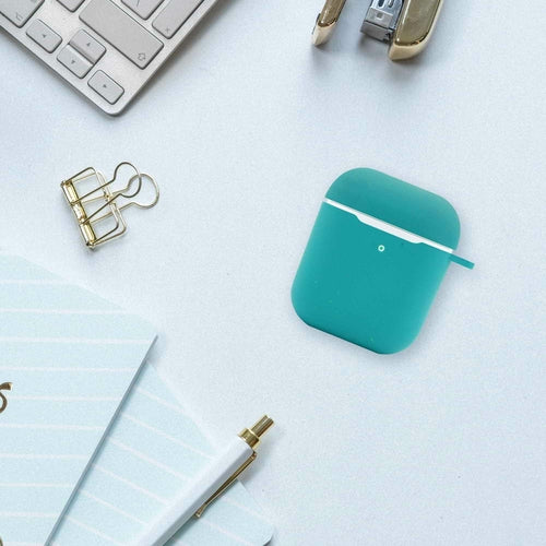 Teal air pod case on a desk with office supplies