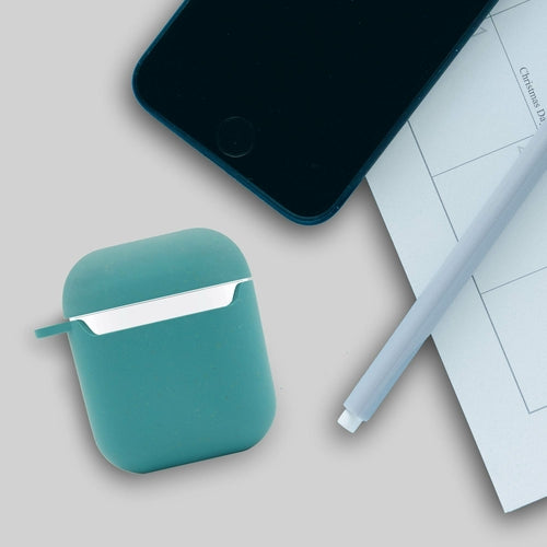 Teal square-shaped case with a white interior, surrounded by wheat stalks on a white background