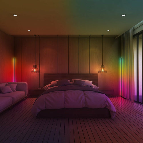 Modern bedroom with wooden floor, bed, and colorful wall lighting