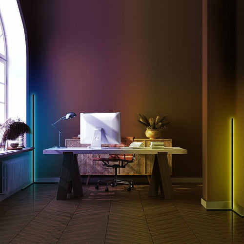 Modern home office with a desk, chair, and computer setup in a dimly lit room.