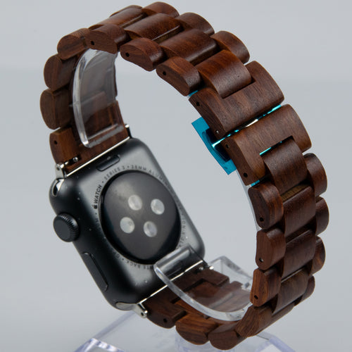 Smartwatch with a wooden band on a clear stand against a light gray background