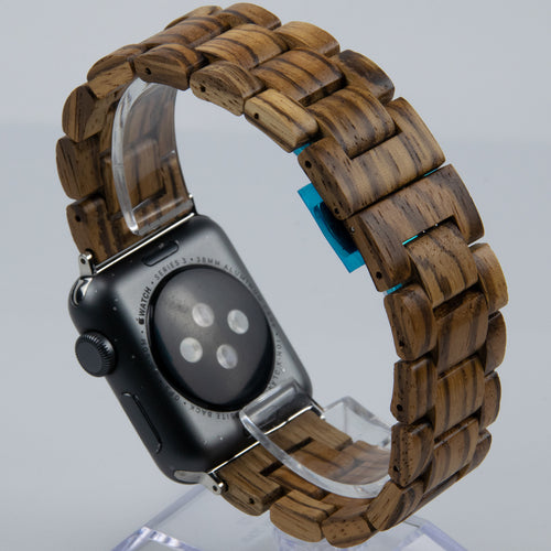 Smartwatch with a wooden band on a clear stand against a light gray background