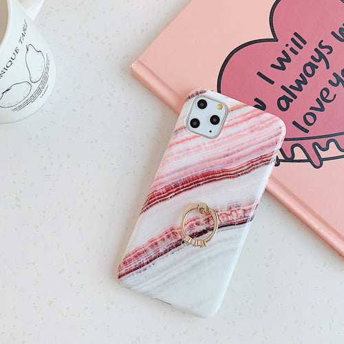 Phone case with pink and white marble pattern on a light surface