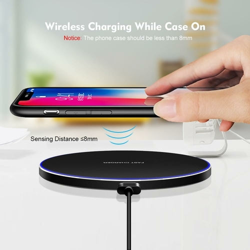 Wireless charging case with a phone being charged on a white surface.